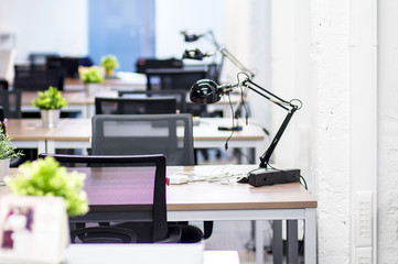 The interior of the office premises of a modern company. Work desks in the IT office. Work space for employees of a computer company. Workplace programmers.