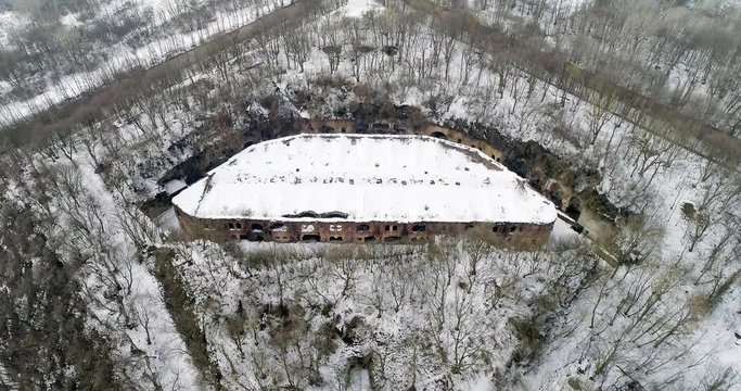 Aerial view of beautiful ancient fortress in forest in winter. Tarakaniv Fort.