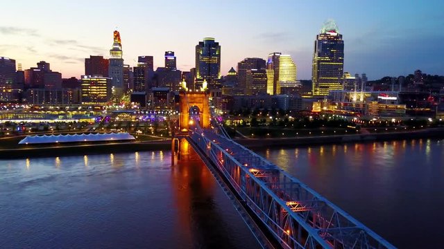 A beautiful evening aerial shot of Cincinnati Ohio with bridge crossing the Ohio River foreground.