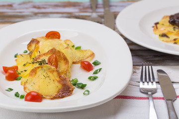 Fish in baked potatoes decorated with cherry tomatoes