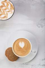 Coffee cup of cafe latte with heart latte art on top