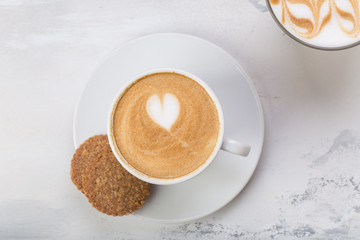 Coffee cup of cafe latte with heart latte art on top