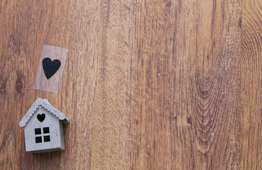 Real estate and mortgage . Wooden house  on the wooden background .