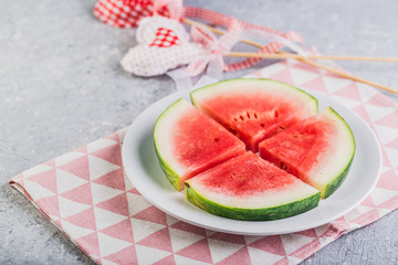 Watermelon slices on a plate in summer time red green