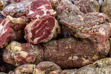 Closeup, assorted different kinds of meat: salami, sausages, smoked meat.