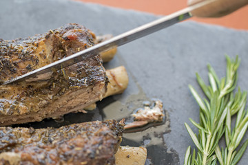 Ribs of pork and a knife cutting.