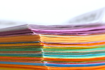 Colorful stack of papers on white background