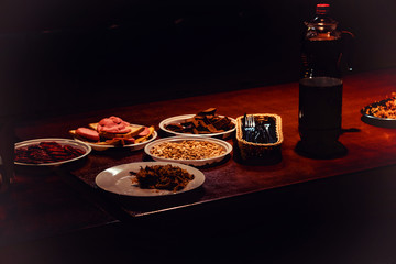 Plates with food on the table in a dark room