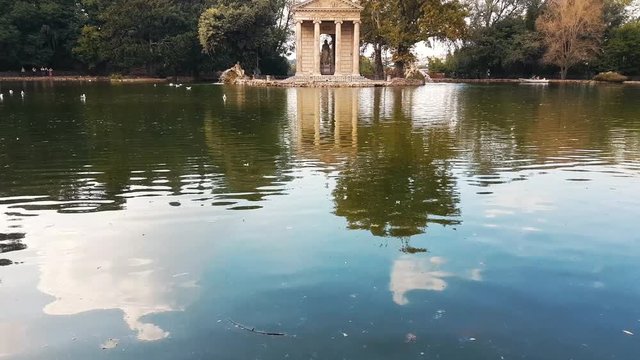 Reveal shot of Tempio di Esculapio, park, Rome, Italy