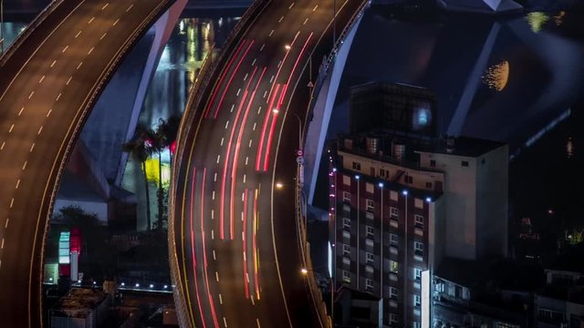 Moving dolly aerial view of highway bridge with busy traffic in nigth Taipei city. Beautiful Timelapsed freeway in cityscape. Cars ligth exposure. Mountain Xindian-Dan