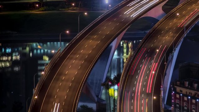 Hyperlapse aerial view of highway bridge with busy traffic in nigth Taipei city. Beautiful Timelapsed freeway in cityscape. Cars ligth exposure. Mountain Xindian-Dan