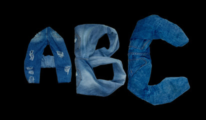    ABC letters indicate the alphabet laid out the jeans on a black background
