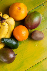 Tropical fruit on yellow wooden background, fresh food