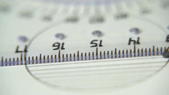 Hand drawing a line with pencil using ruler on white paper close up, circles, geometry. Sequence.