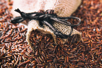 Wild red rice in a bag closeup