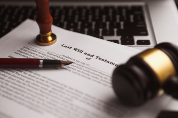 Notary's public pen and stamp on testament and last will.