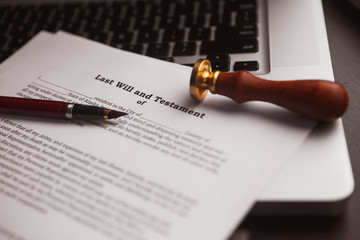 Notary's public pen and stamp on testament and last will.
