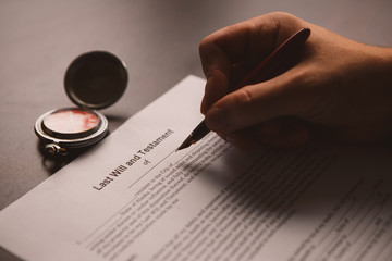 Notary's public pen and stamp on testament and last will.