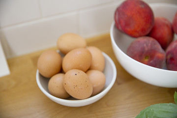 A bowl of organic eggs on a counter