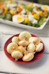 Small onions in a red bowl 