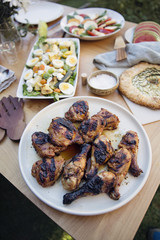 Grilled chicken and salad on a dinner party table 
