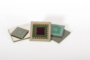 Computer electronic chips isolated on white arranged in a stack. The chips are placed upside down or facing the viewer. there are different chips in the stack