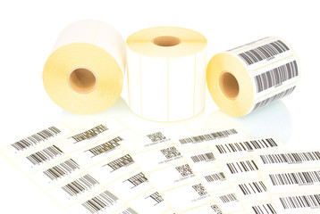 White label rolls and printed barcodes isolated on white background with shadow reflection. White...