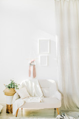 Interior design concept. Bright room with white walls, eucalyptus in straw basket, chair and curtains.