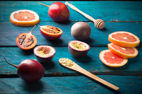 passion fruit and tamarillo on wooden table