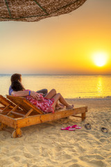 Couple watching sunrise on the beach of Red Sea in Egypt