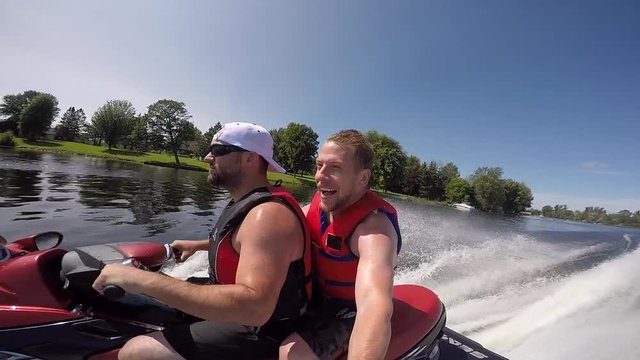 two guys on a seadoo smiling having time of his life selfie