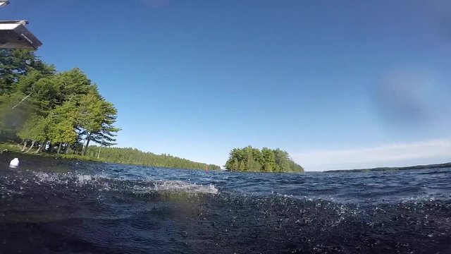 young girl dives into lake from floating tower slow motion