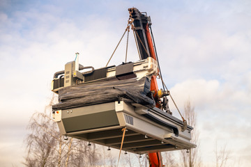 Cnc machine  hanging on hook crane. 