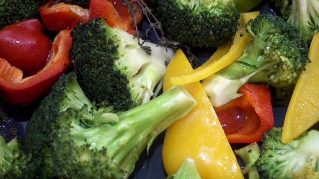 Close-up slices of vegetables as a background. Colorful fresh pepper, cauliflower and broccoli mixed. HD video