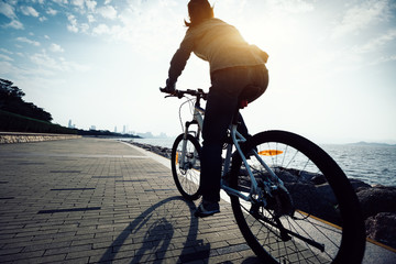 cyclist riding mountain bike in the sunrise coast