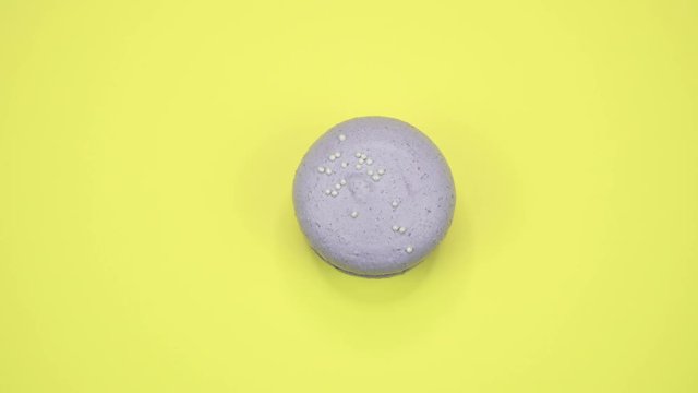 ROTATION: A Colorful Macaroons are rotating on a yellow background