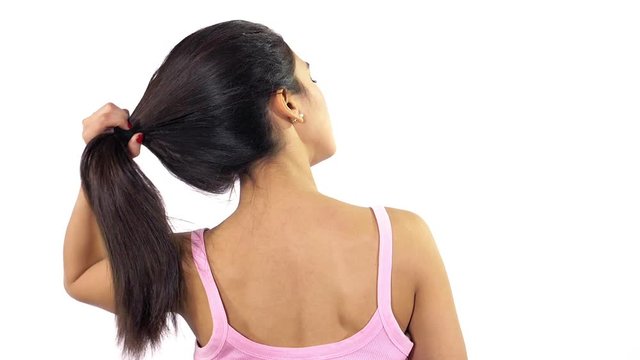 Gorgeous hispanic woman undoing ponytail shaking long hair slow motion