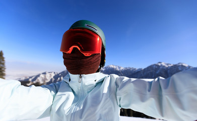 Fototapeta na wymiar one snowboarder taking selfie on winter mountain top