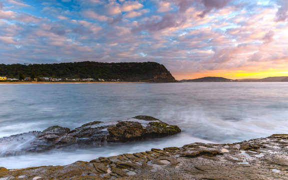 Sunrise Seascape with Clouds and Rock Platform