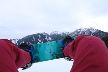 Fototapeta na wymiar snowboarding legs in winter mountains