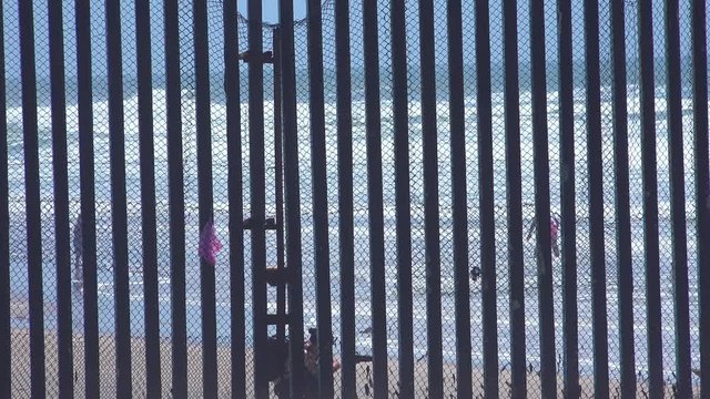 Mexican visit the beach at the U.S. Mexico border fence in the Pacific Ocean between San Diego and Tijuana.