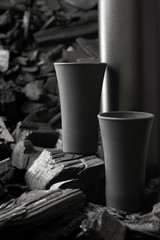 Two matte black shot glass .On charcoal background. Black edition.Creative.Let's drink.Cheers.Mockup.Copy space.Pour it.Still life