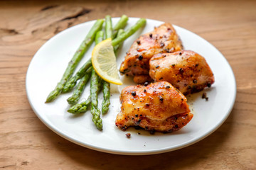 Plate of grilled chicken meat and asparagus