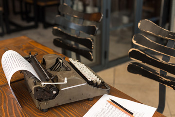 Writing and freelance concept. Retro typewriter in dark interior