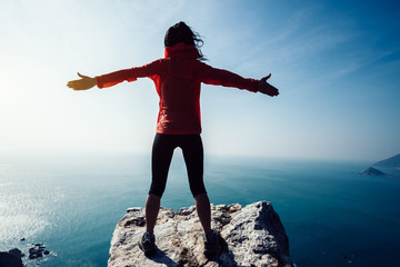 freedom female standing on sunrise windy coast