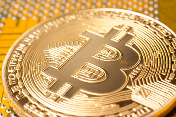 Fototapeta na wymiar Golden bitcoin on a computer motherboard. Cryptocurrency virtual money