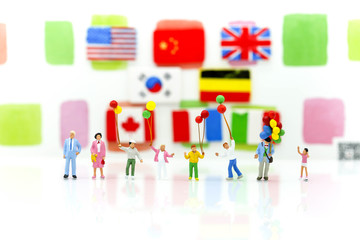 Miniature people : family and children with colorful ballons standing with nation flag background.