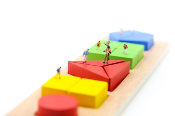 Miniature people : children with wooden block toy, Education concept.