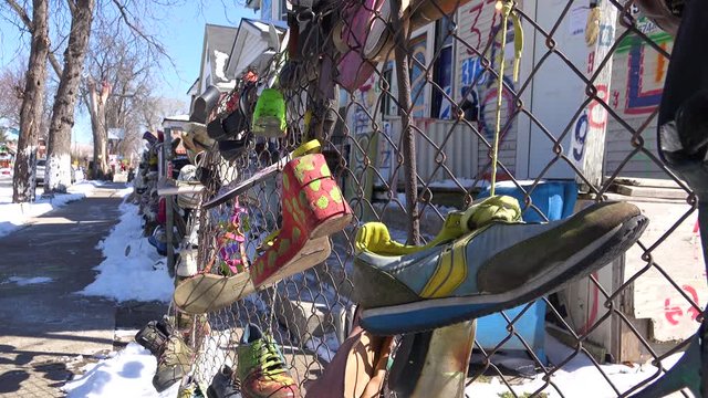 Shoes hang on a fence in a ghetto section of downtown Detroit, Michigan.