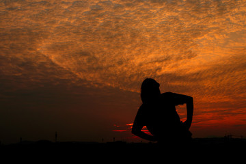 Silhouette of woman exercises at sunset Yellow on sky beautiful in summer